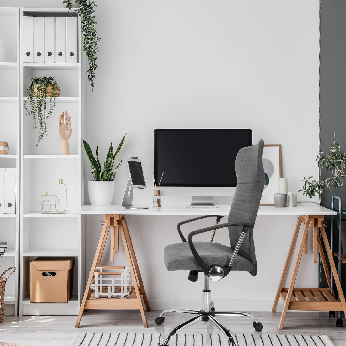 Grauer Home-Office-Bürostuhl ARTON 40 mit Armlehnen und Rollen vor einem Schreibtisch von hjh OFFICE