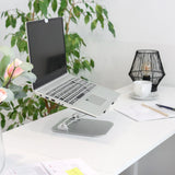 Silberne Laptopunterlage LAPTOP STAND mit verstellbarem Gestell auf einem weißen Schreibtisch von hjh OFFICE