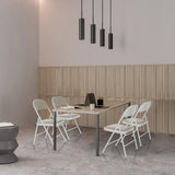 Vier graue Klappstühle TUDELA W mit Kunstlederbezug an einem Tisch von hjh OFFICE