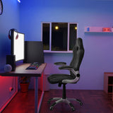 Schwarzer Gamingstuhl GAME SPORT mit Armlehnen an einem Schreibtisch in einem beleuchteten Raum von hjh OFFICE