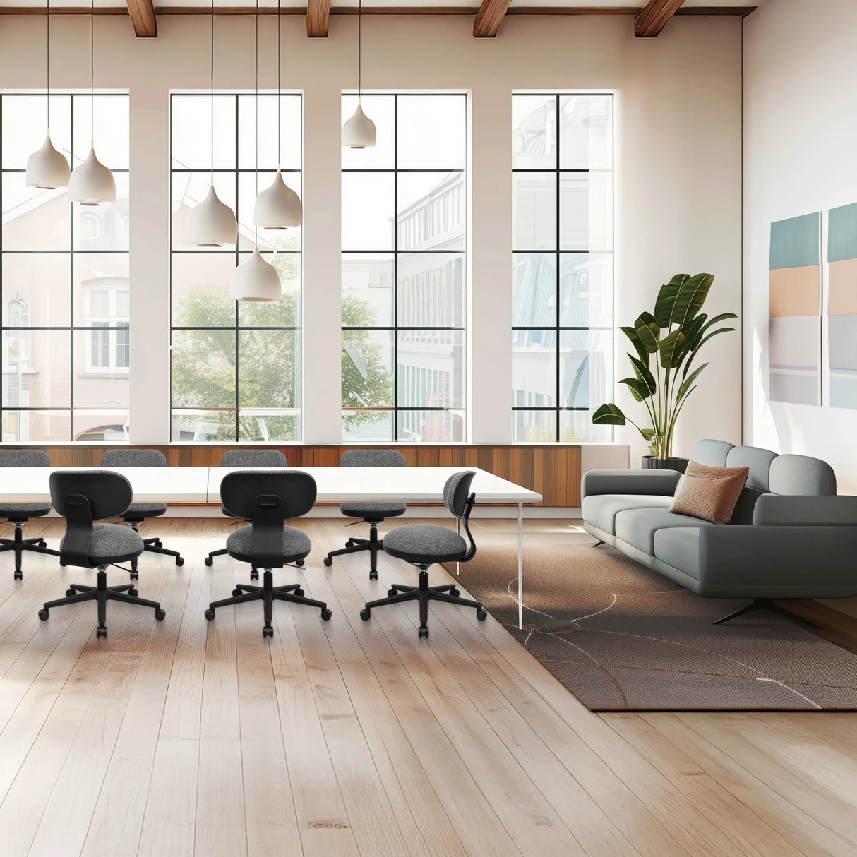 Grauer Home-Office-Bürostuhl SITMOTION B mit Rollen und Armlehnen in einem hellen Büro von hjh OFFICE